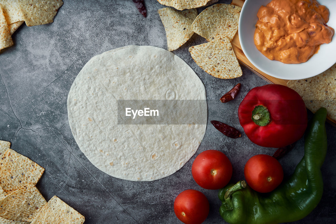 Preparing mexican fajitas with cakes, tomato, pepper, spicy and meat. concept of mexican food.