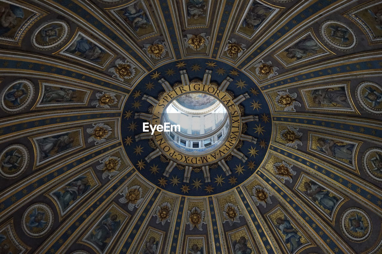ceiling, dome, architecture, built structure, indoors, low angle view, pattern, no people, cupola, directly below, travel destinations, ornate, religion, place of worship, building, shape, geometric shape, belief, spirituality, architectural feature, circle, vault, history, mural, the past, city, day, craft, creativity, catholicism, tourism, ancient history