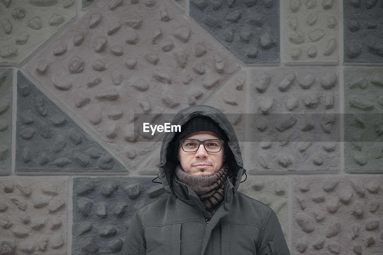 Portrait of man against textured wall