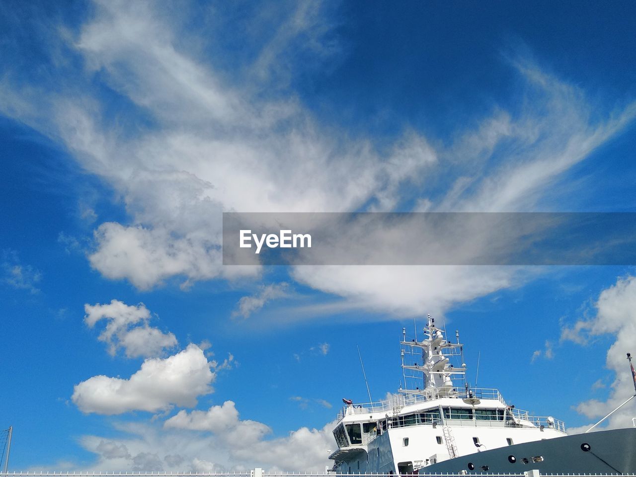 LOW ANGLE VIEW OF COMMUNICATIONS TOWER AGAINST SKY