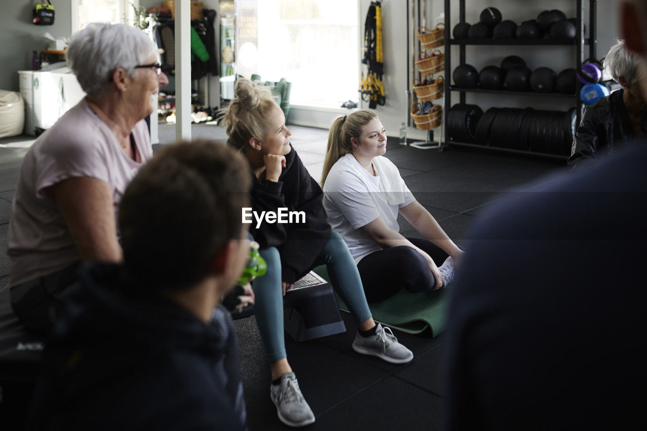 Group of people talking together in gym