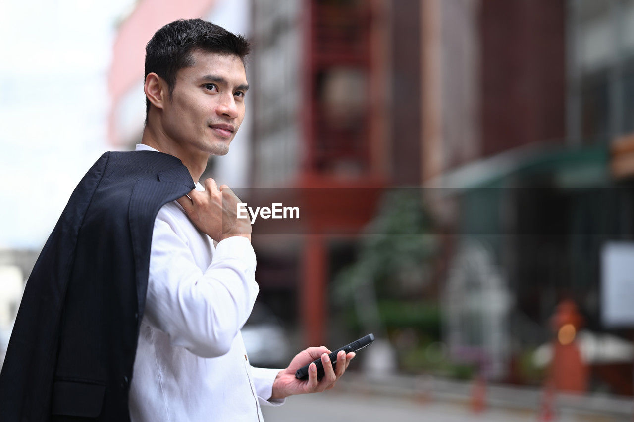 portrait of young man using mobile phone