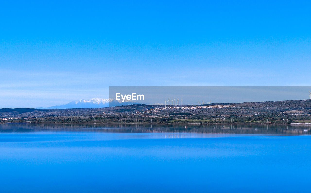 SCENIC VIEW OF LAKE AGAINST BLUE SKY