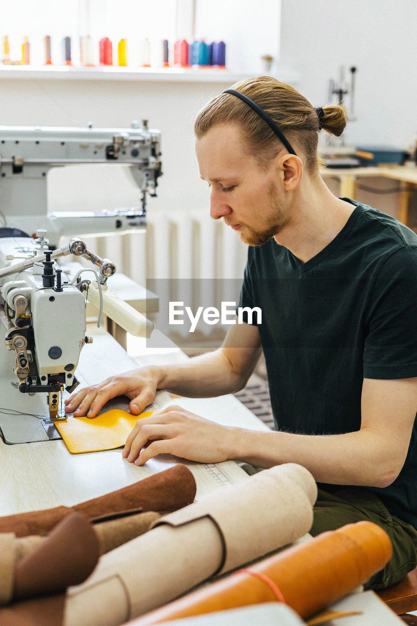 Side view of young man working at home