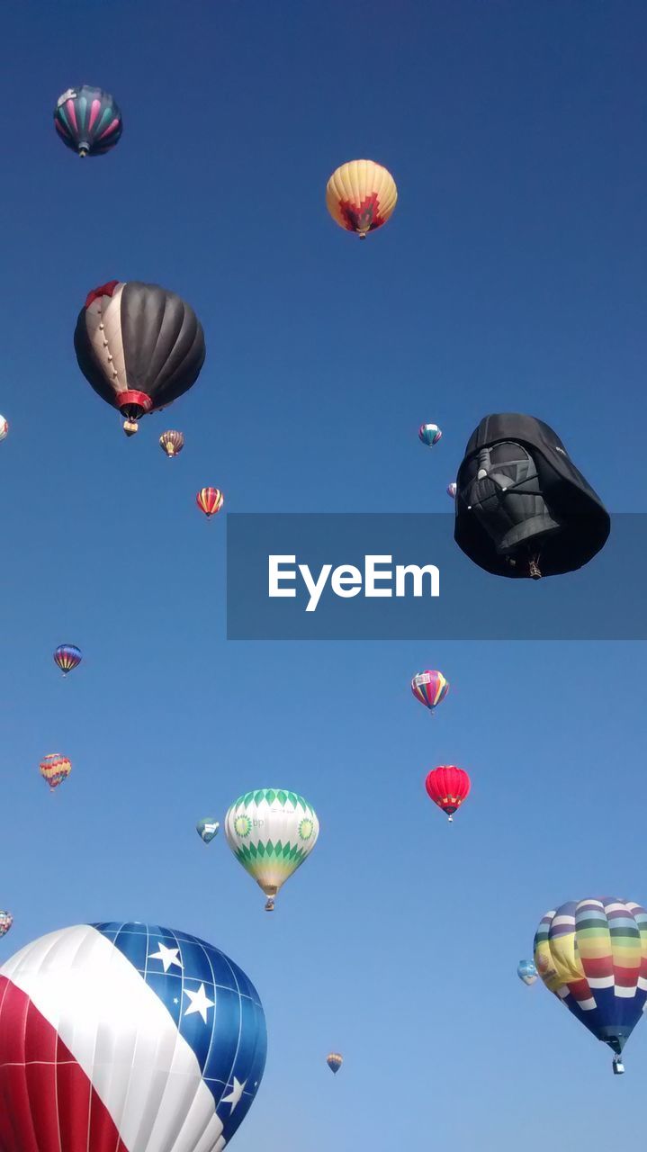 LOW ANGLE VIEW OF MULTI COLORED BALLOONS