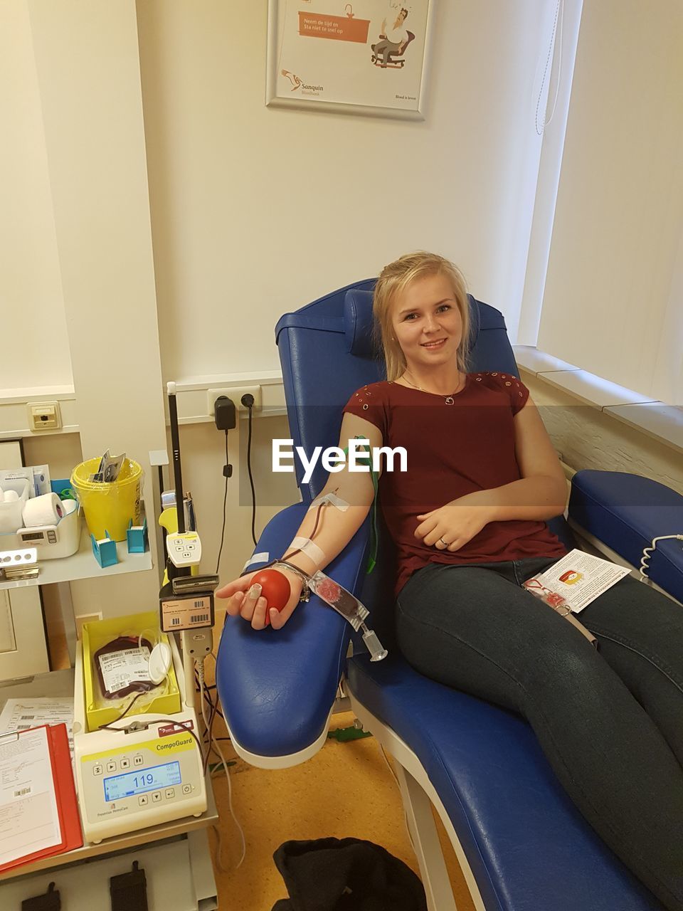 Portrait of young woman donating blood