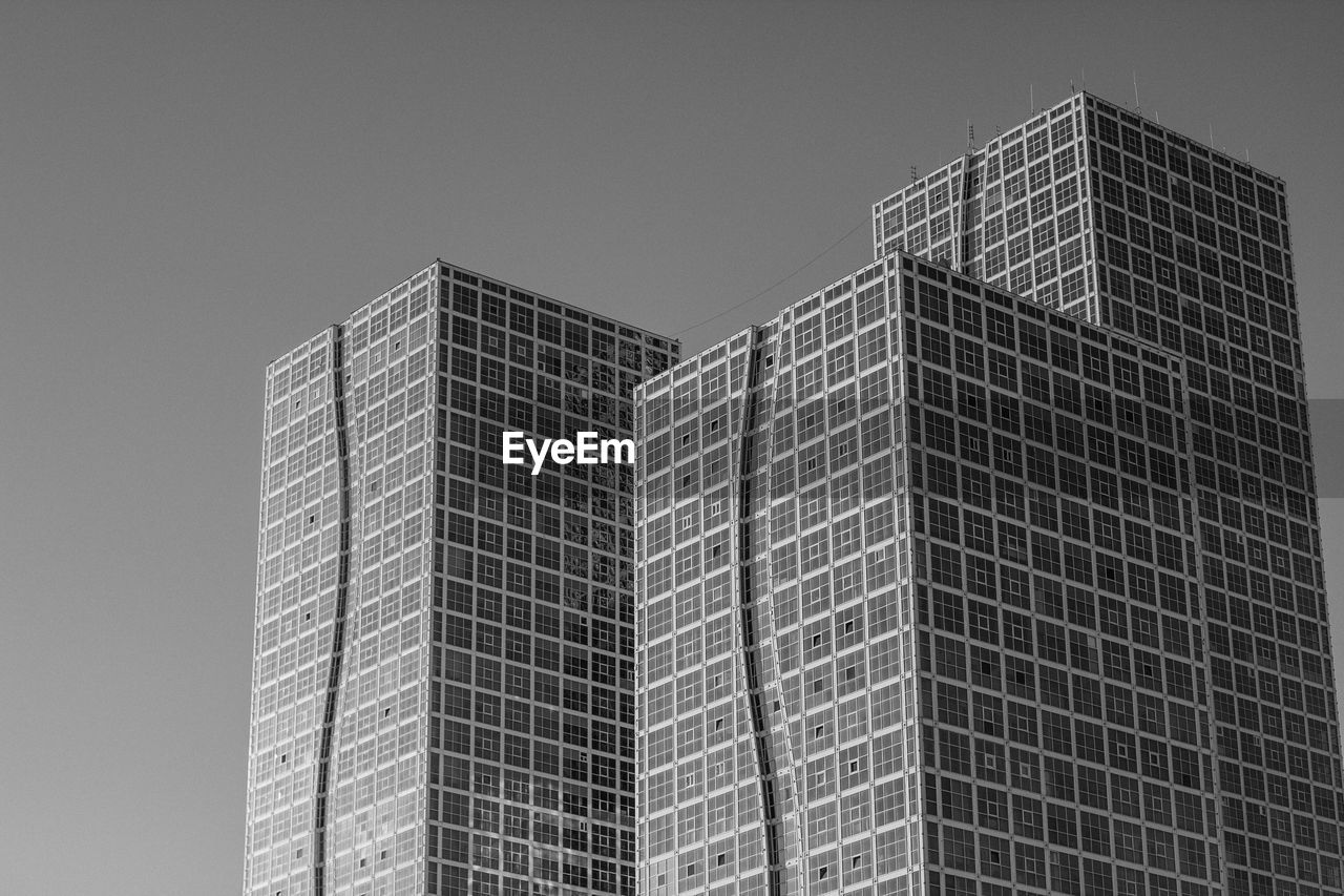 Low angle view of modern buildings against clear sky