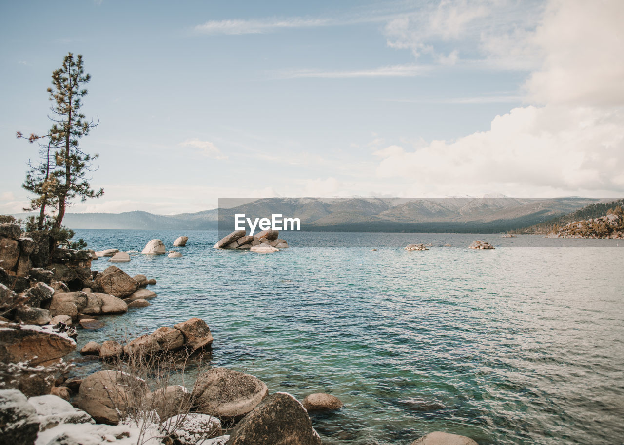 ROCK FORMATIONS IN SEA AGAINST SKY