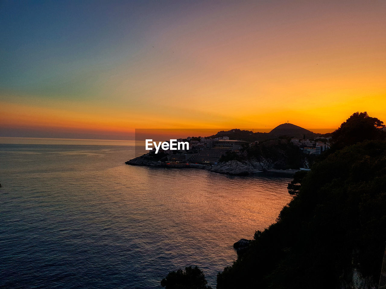 Scenic view of sea against sky at sunset