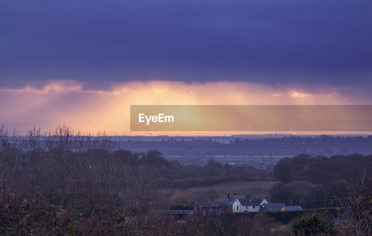 Scenic view of buildings against sky during sunset