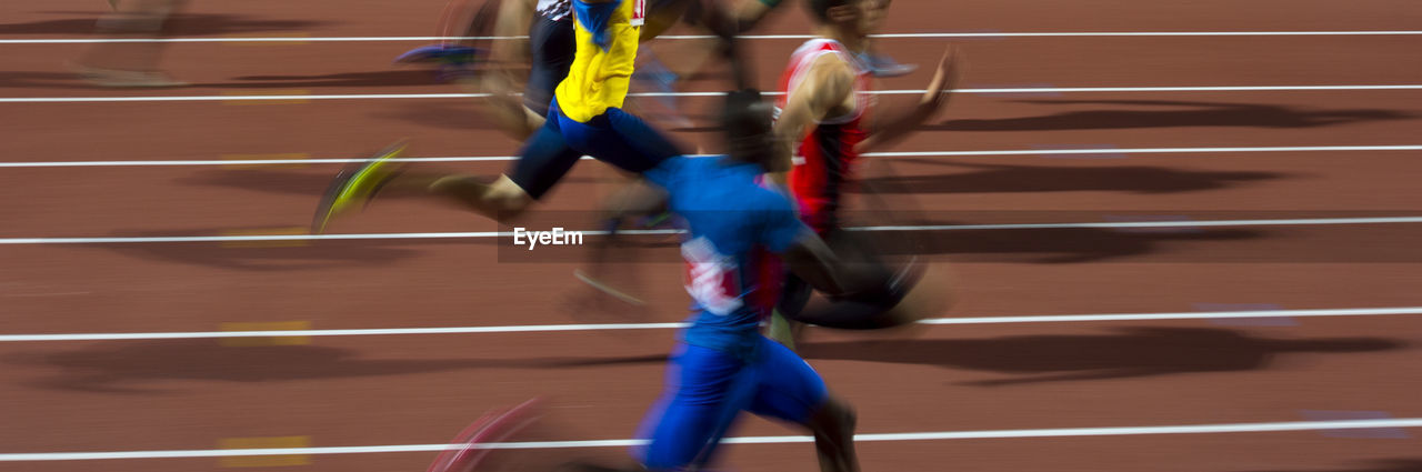 Blurred motion of athletes running on track