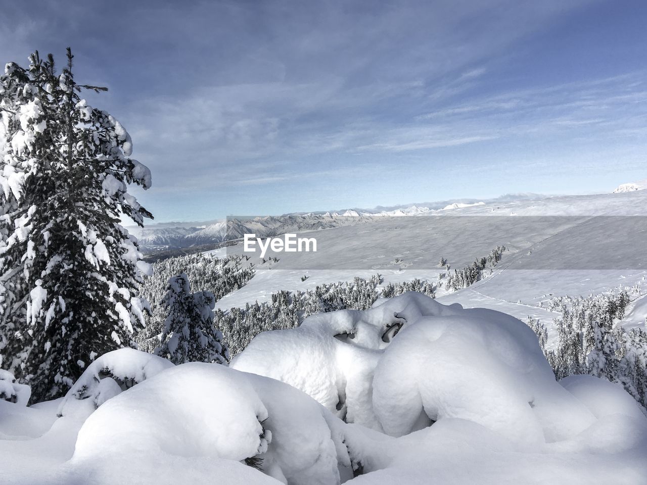 Snow covered landscape against sky