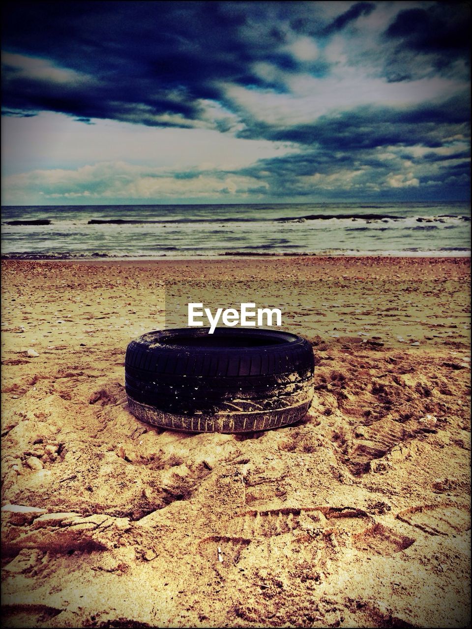 Tire on sandy beach
