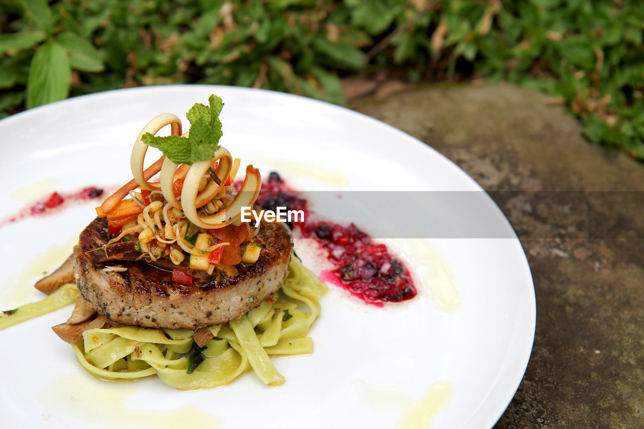 Close-up of burger steak served on table