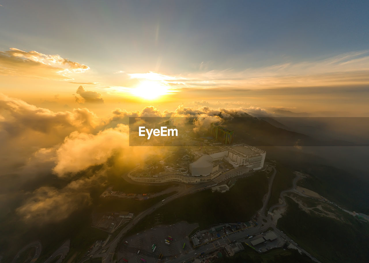 Aerial view of cityscape against sky during sunset