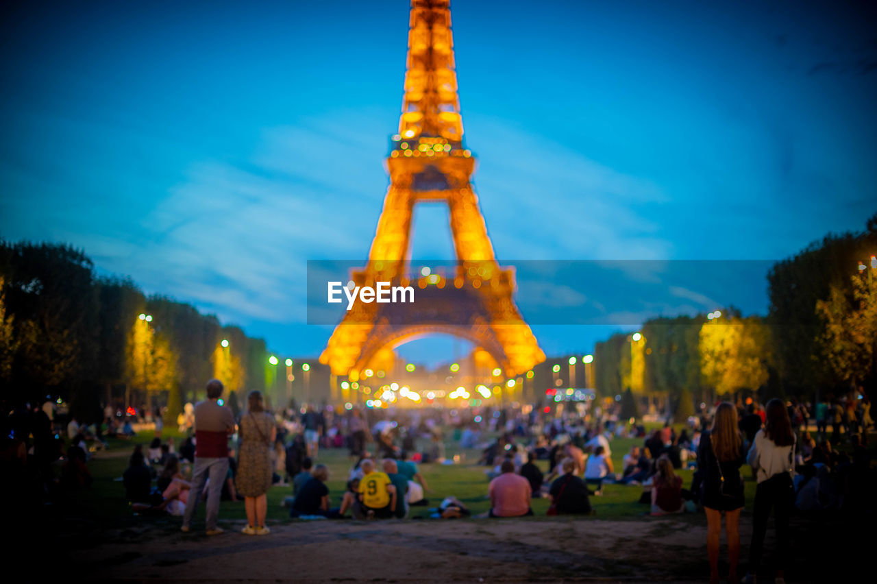 crowd, night, architecture, travel destinations, large group of people, group of people, sky, tourism, built structure, illuminated, evening, city, nature, travel, building exterior, tourist, outdoors, plant, tower, history, tree, holiday, dusk, landmark, the past, men, celebration, women, city life