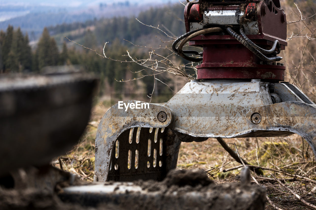 CLOSE-UP OF OLD RUSTY METAL ON FIELD