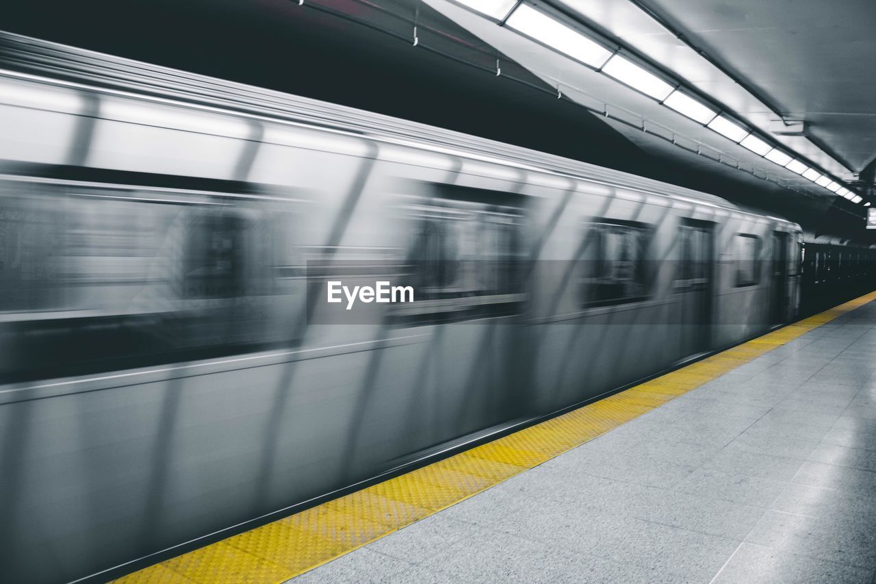 Blurred motion of train at railroad station