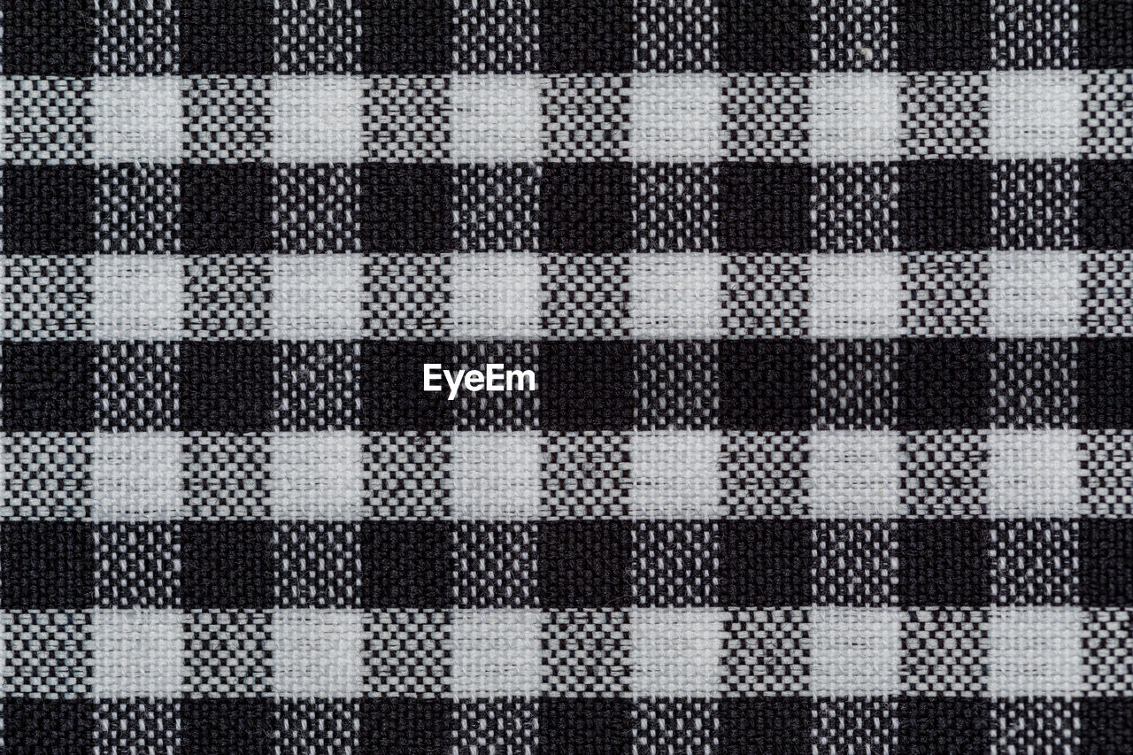 Checkered fabric background. black cell. top view, flat lay.