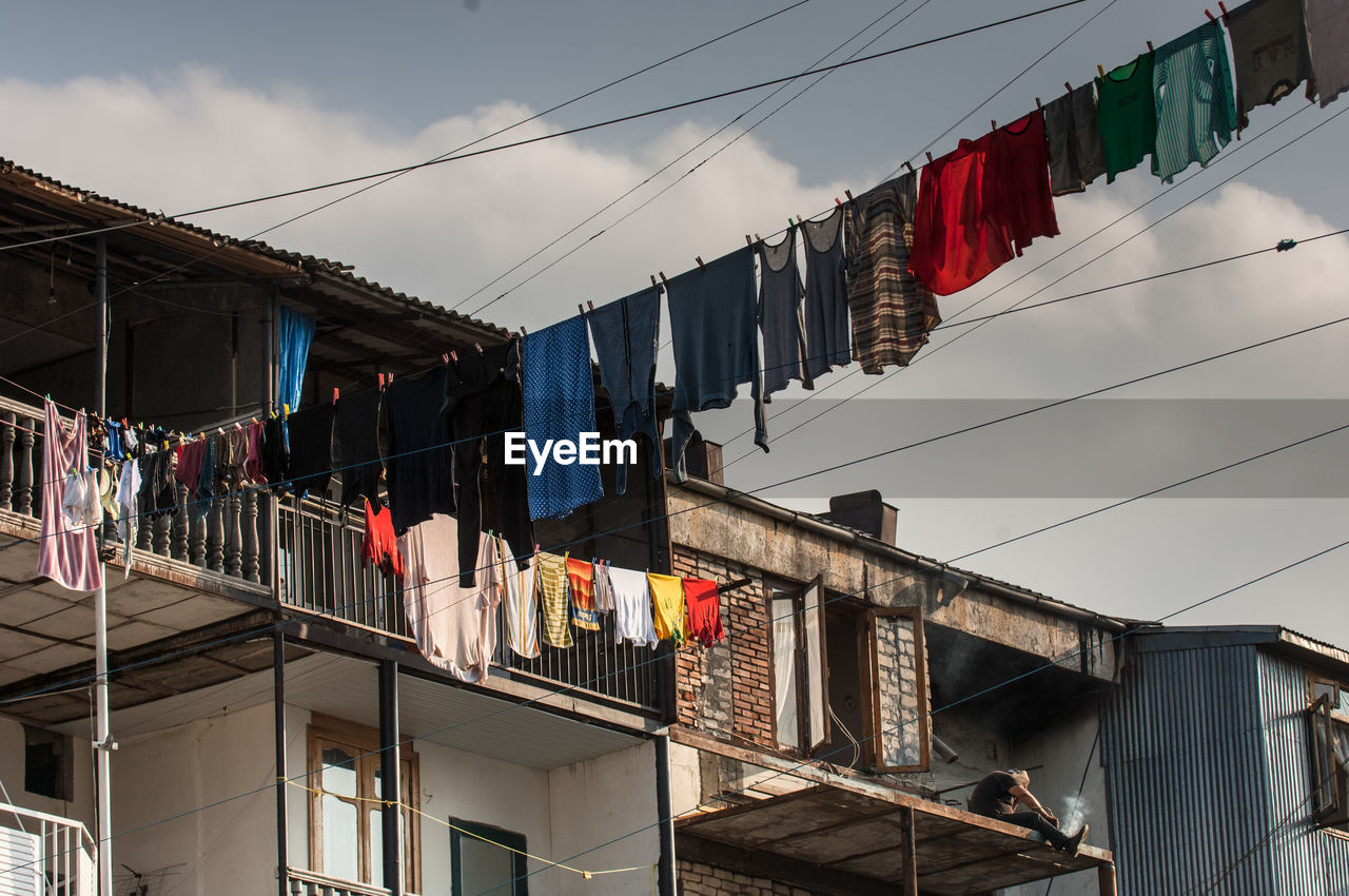 Low angle view of clothesline hanging from balcony