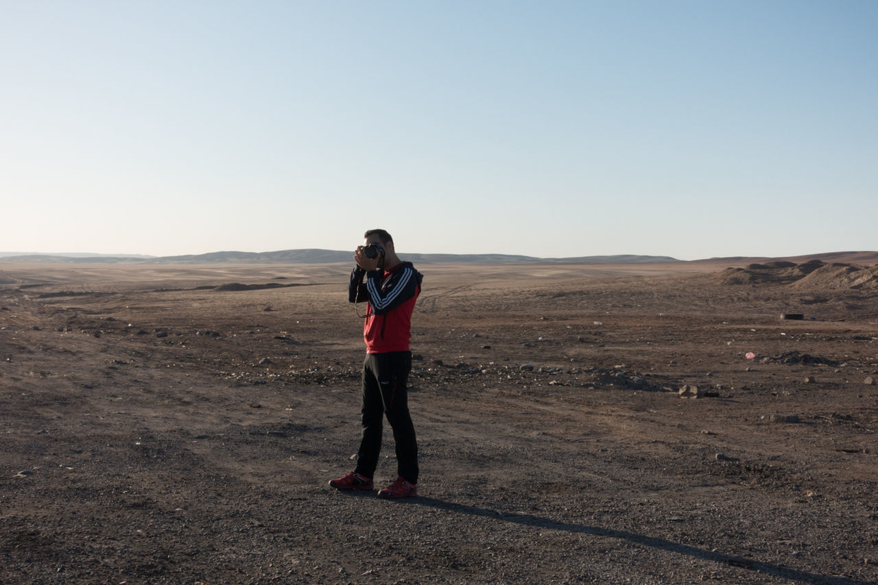 WOMAN STANDING ON LANDSCAPE