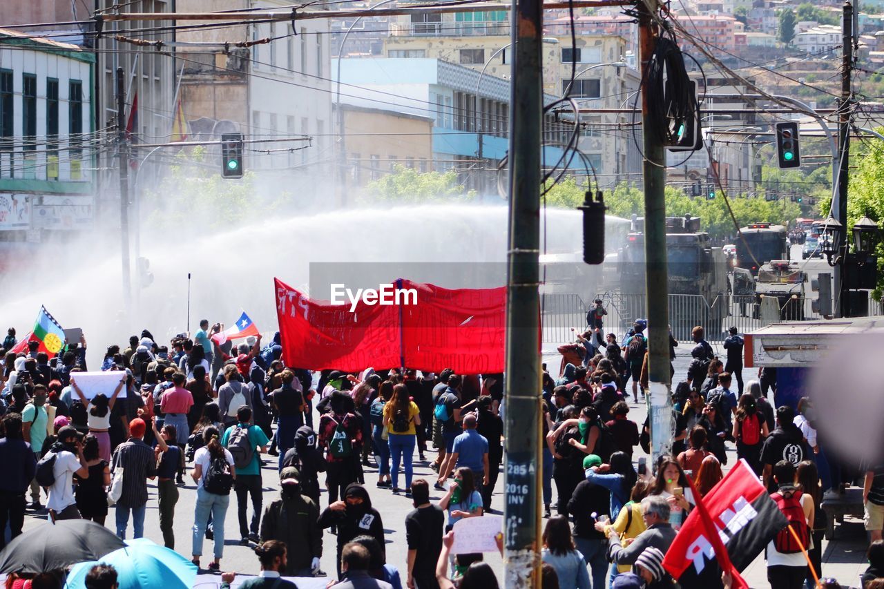 PEOPLE ON STREET AGAINST BUILDINGS