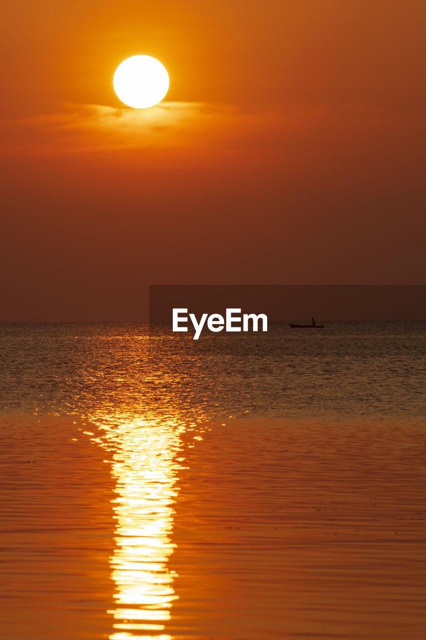 SCENIC VIEW OF SEA AGAINST ORANGE SKY