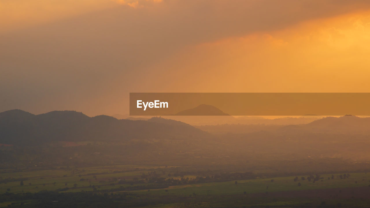 Scenic view of field against sky during sunset