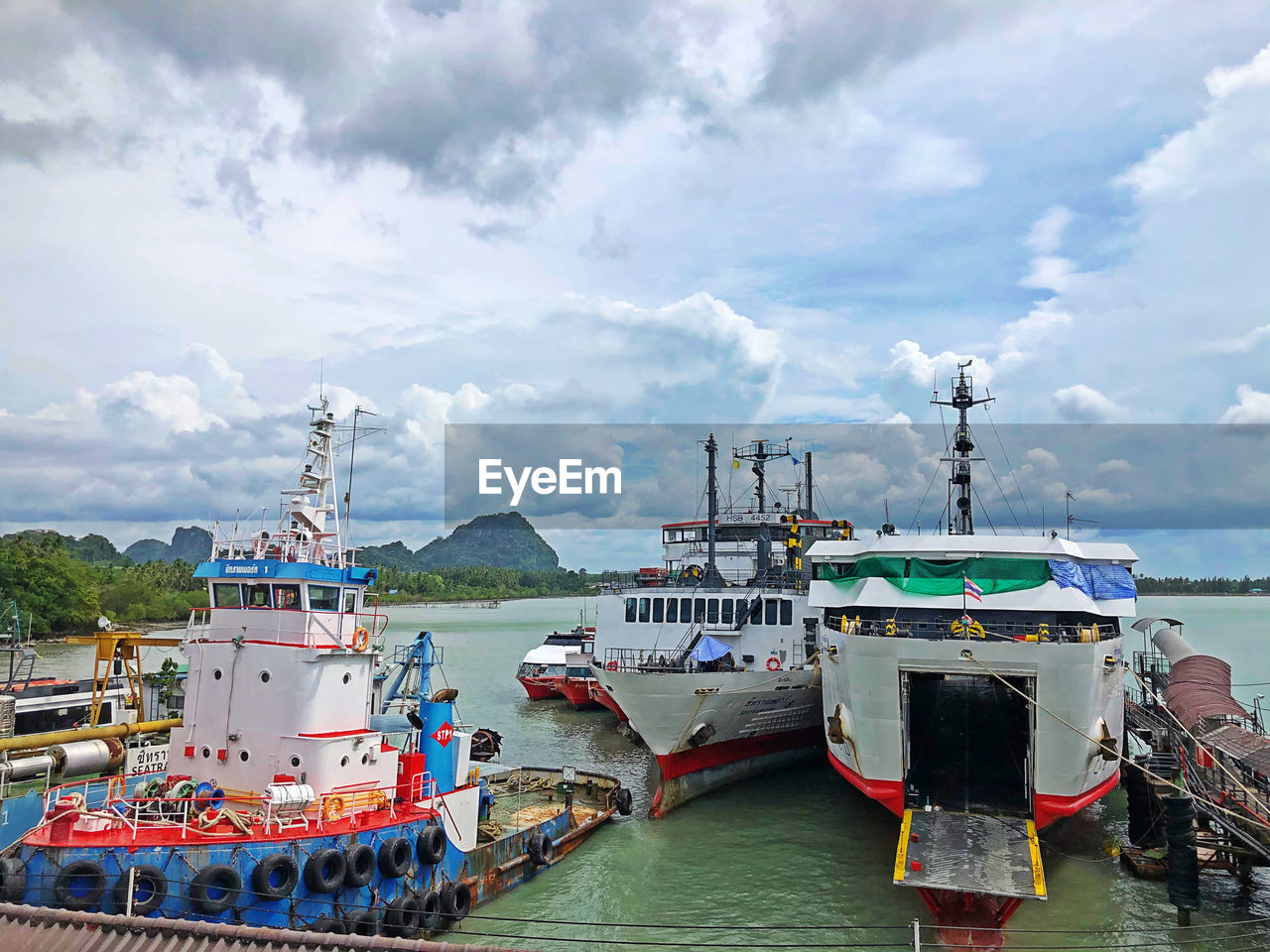 FISHING BOATS IN HARBOR AGAINST SKY