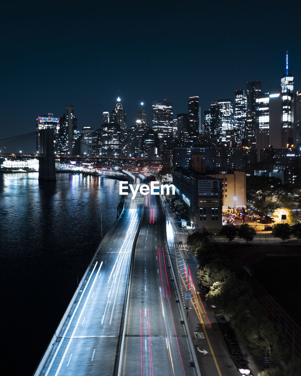 High angle of the highway in new york city at night with the manhattan skyline in the background