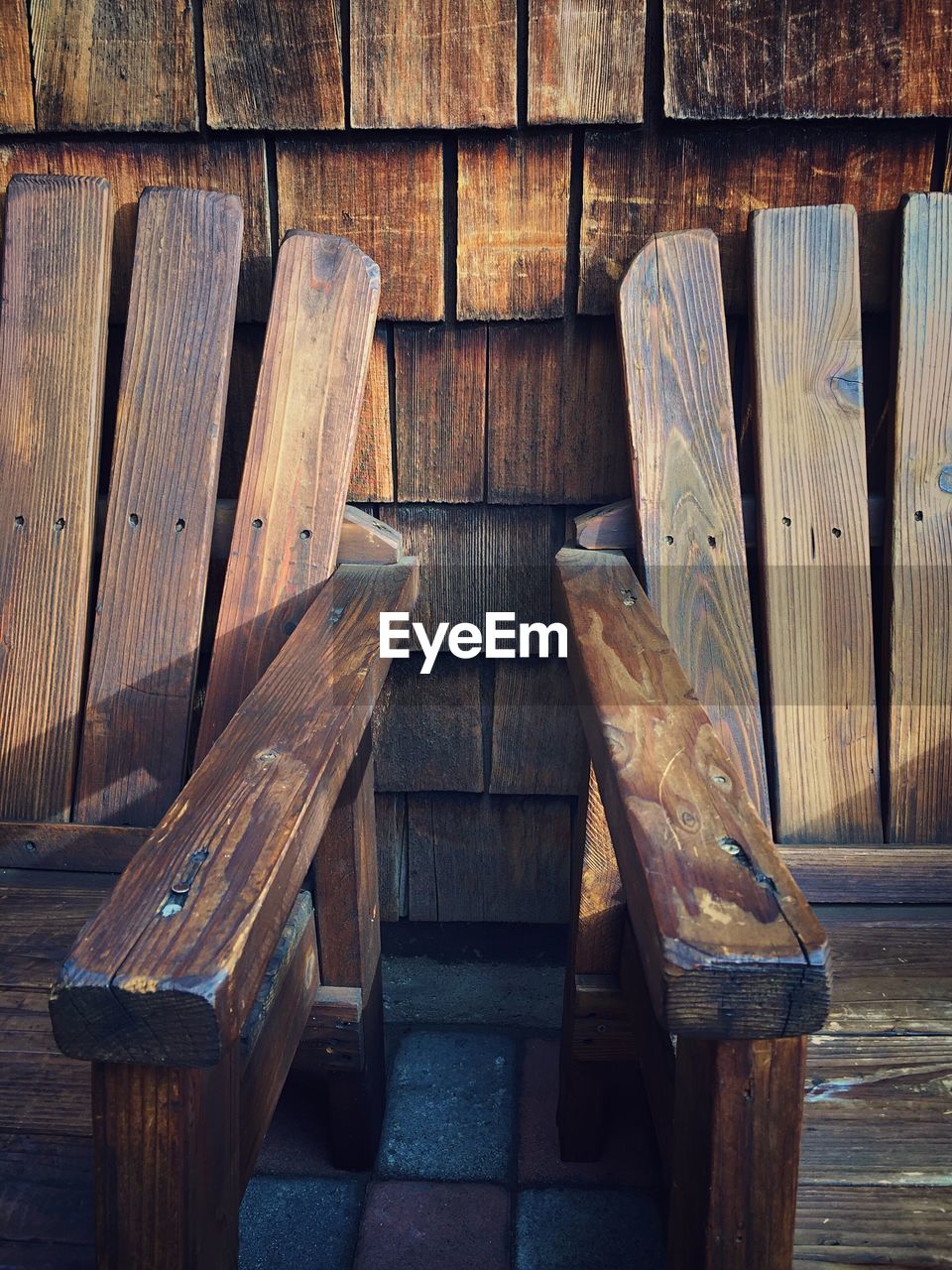 HIGH ANGLE VIEW OF EMPTY BENCH ON TABLE IN OLD WOODEN WALL