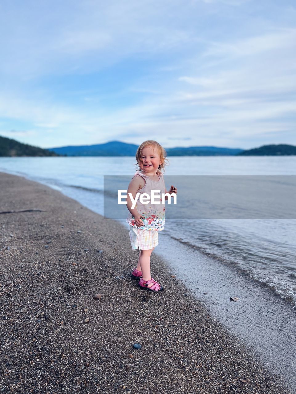 full length of girl standing at beach against sky