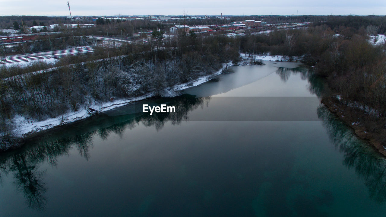 High angle view of river amidst trees during winter