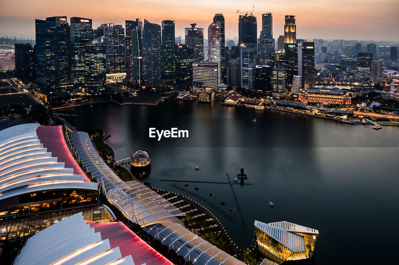 HIGH ANGLE VIEW OF ILLUMINATED CITY BUILDINGS