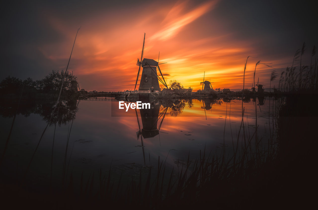 SCENIC VIEW OF LAKE AGAINST ORANGE SKY