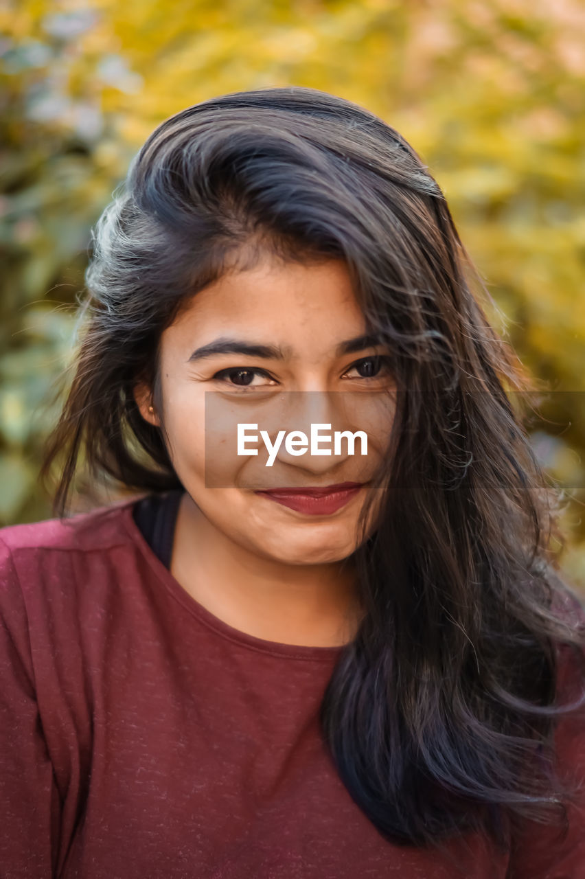 Close-up portrait of smiling young woman