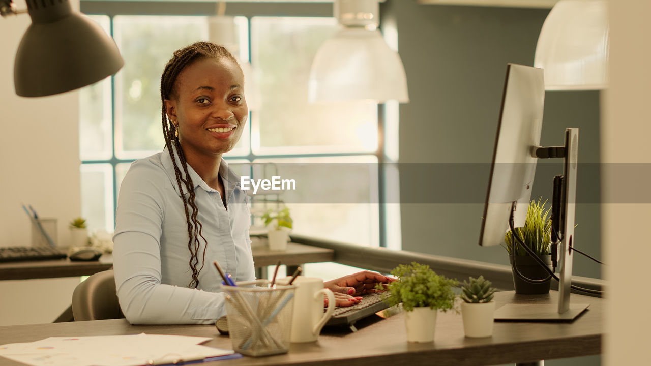 portrait of young woman working in office