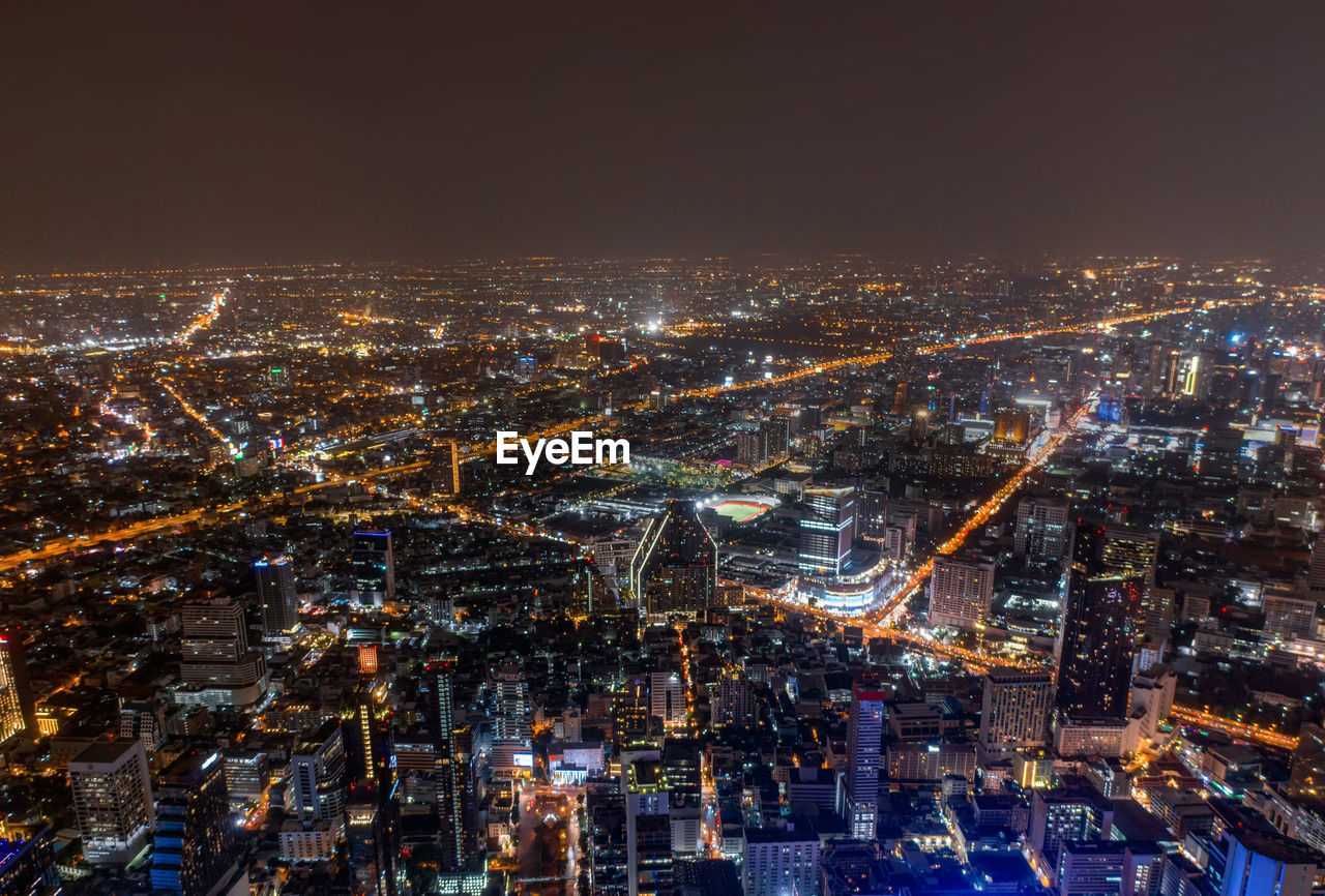 High angle view of city lit up at night