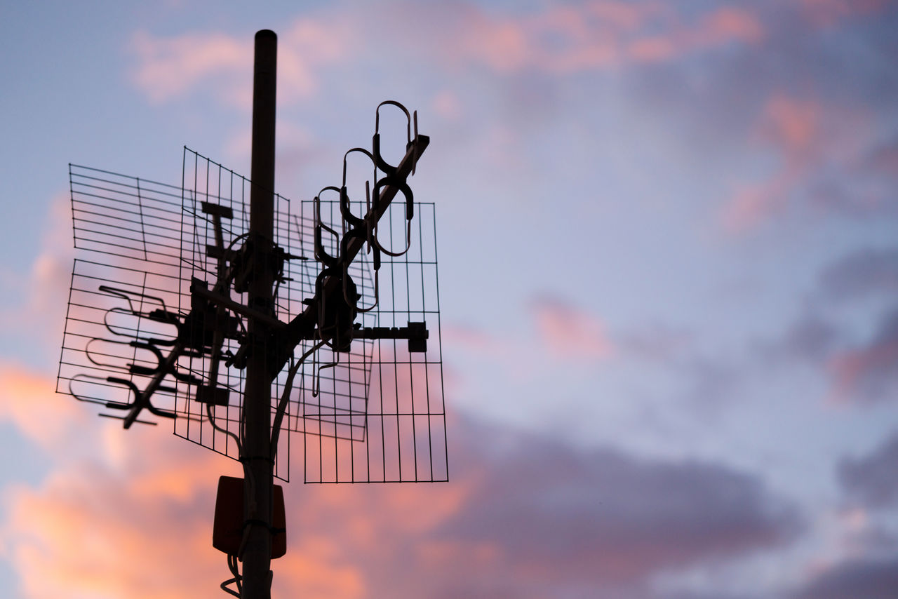 Sunset sky with antenna on the foreground