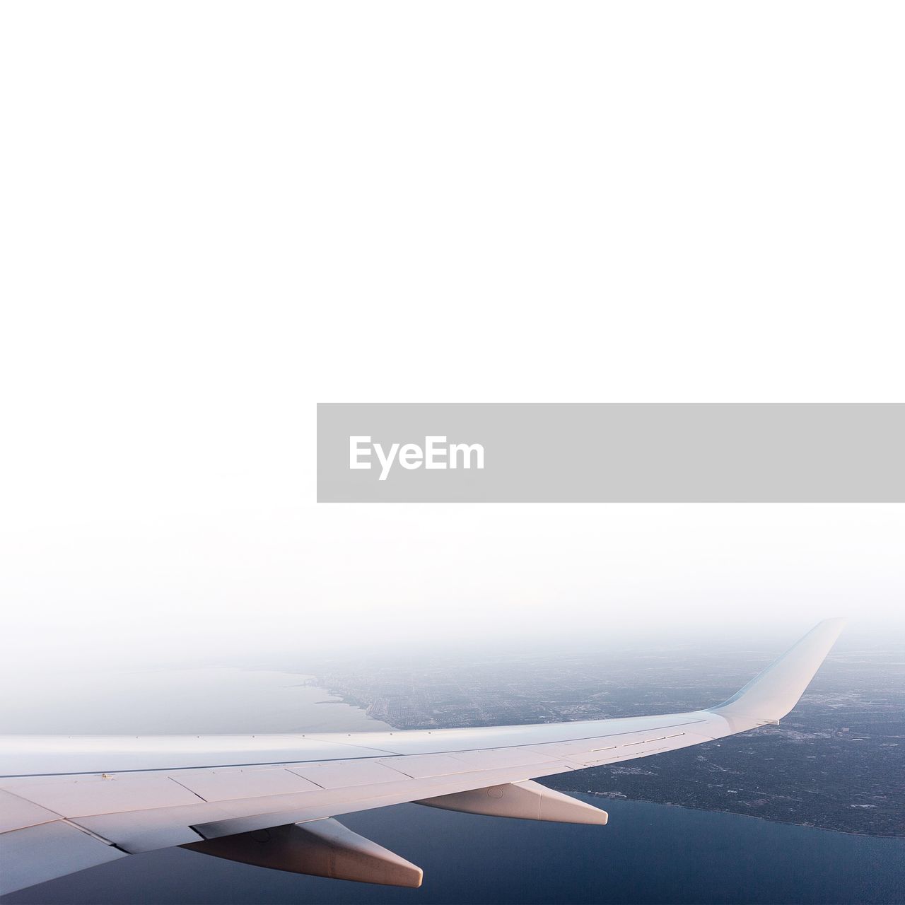 Cropped image of airplane flying over sea