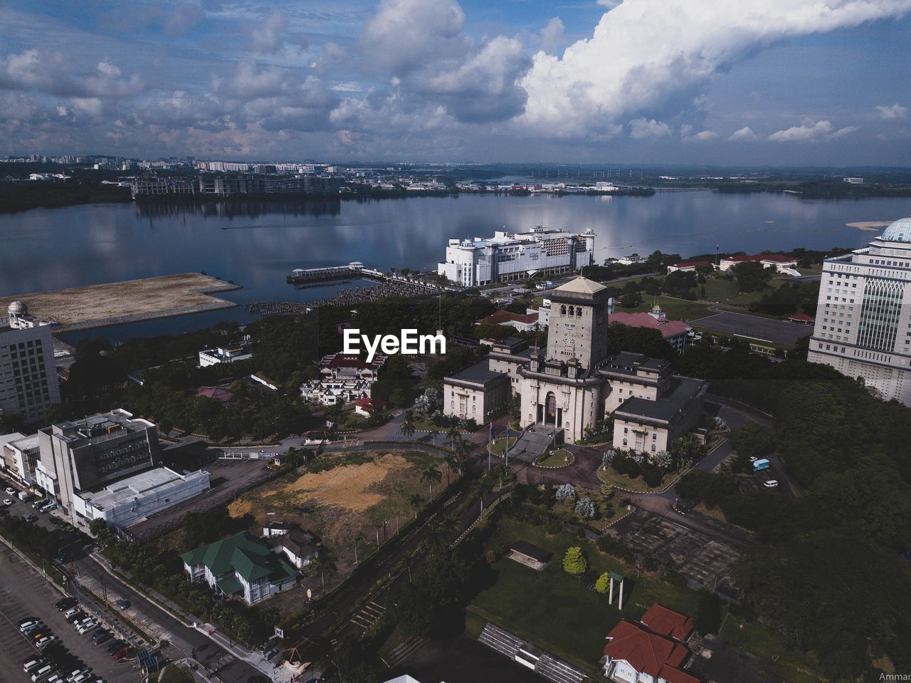 High angle view of city by river against sky