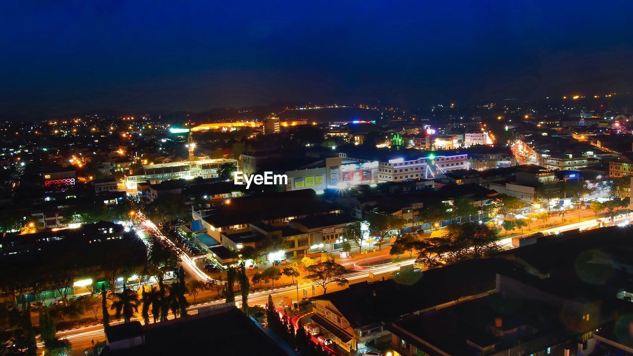 HIGH ANGLE SHOT OF ILLUMINATED CITYSCAPE