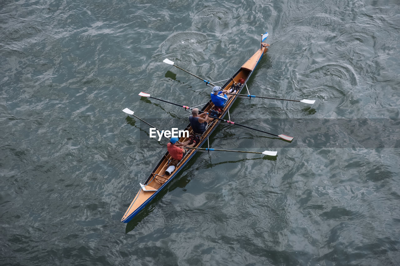 HIGH ANGLE VIEW OF PEOPLE ON RIVER