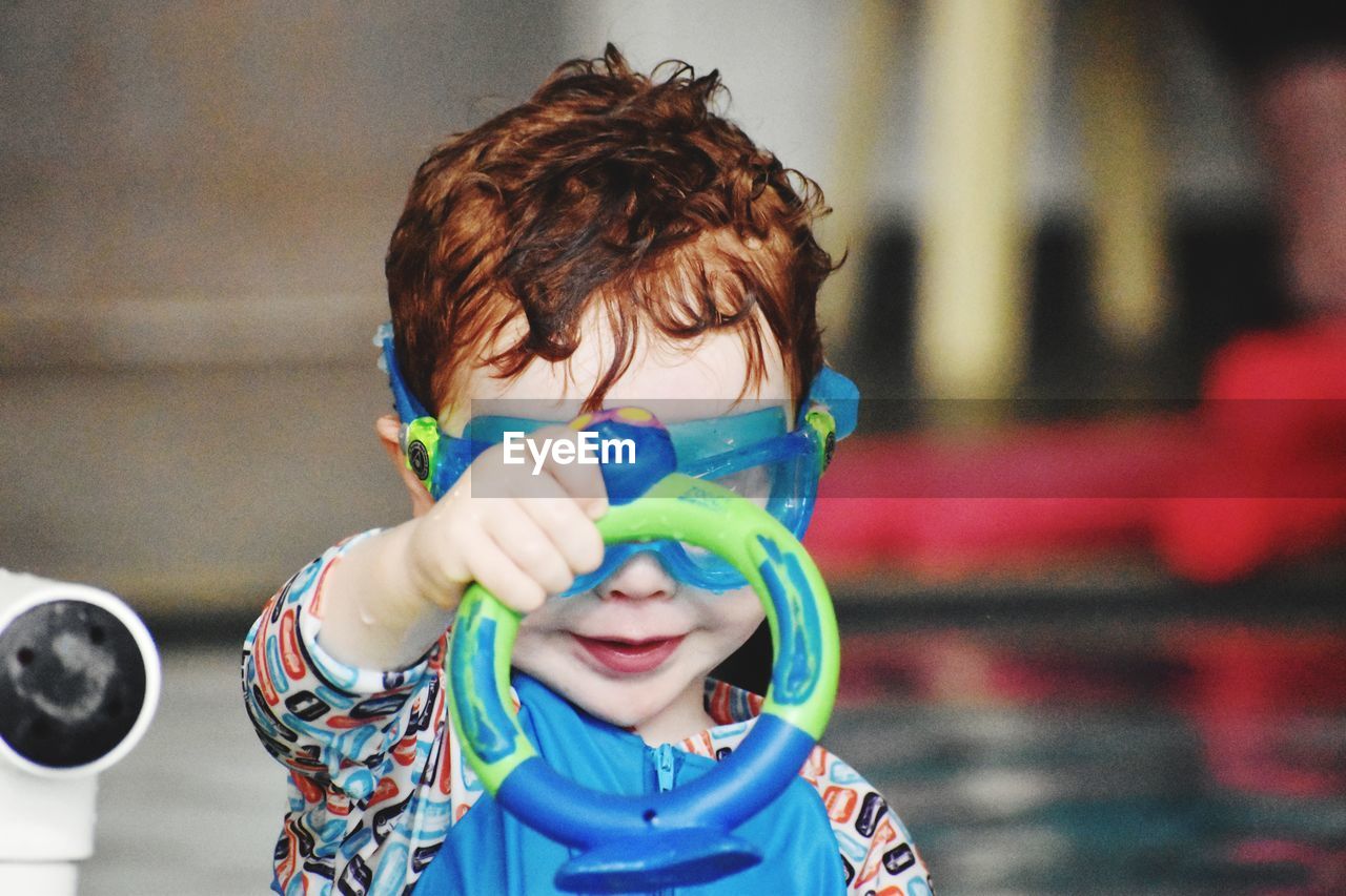 Portrait of cute boy playing in a pool