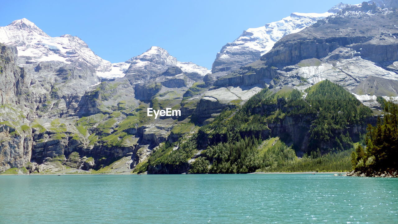 SCENIC VIEW OF LAKE AGAINST MOUNTAIN