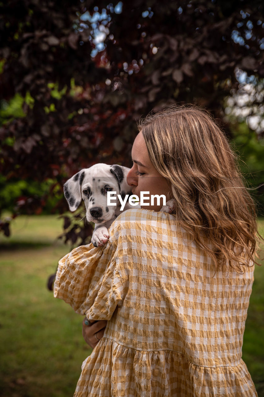 Young woman with a dalmatian puppy