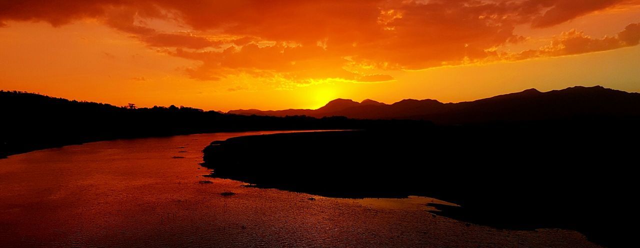 SCENIC VIEW OF LAKE AGAINST ORANGE SKY