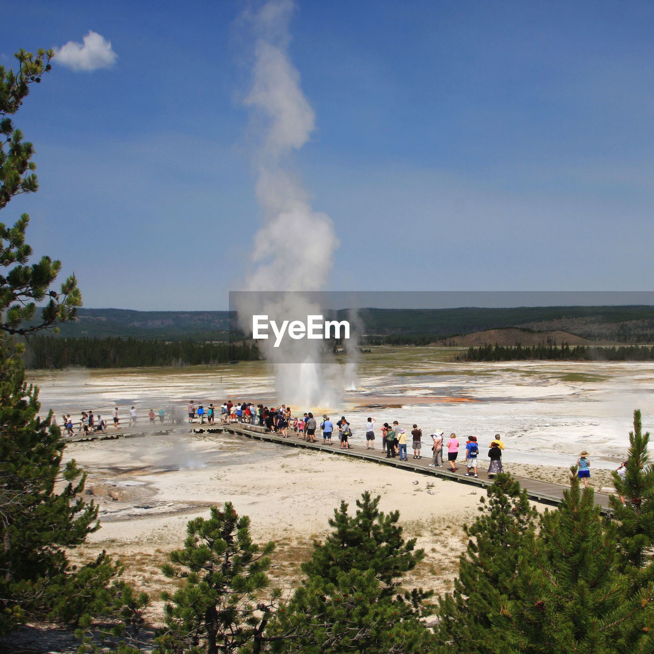 body of water, water, group of people, large group of people, sea, geology, crowd, coast, smoke, nature, sky, cloud, accidents and disasters, heat, erupting, day, environment, geyser, tree, physical geography, motion, power in nature, outdoors, steam, vacation, beach, land, hot spring, travel, shore, beauty in nature, landscape, men, spring