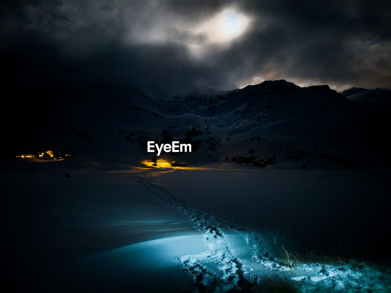 Scenic view of snow against sky during moonshine over mountains