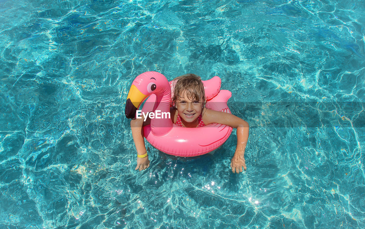 high angle view of girl swimming in pool